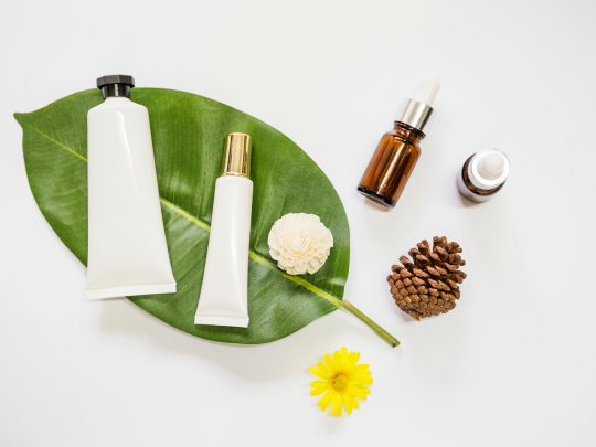 spa-cosmetics-product-on-leaf-with-essential-oil-pinecone-and-flowers-on-white-background 1.jpg